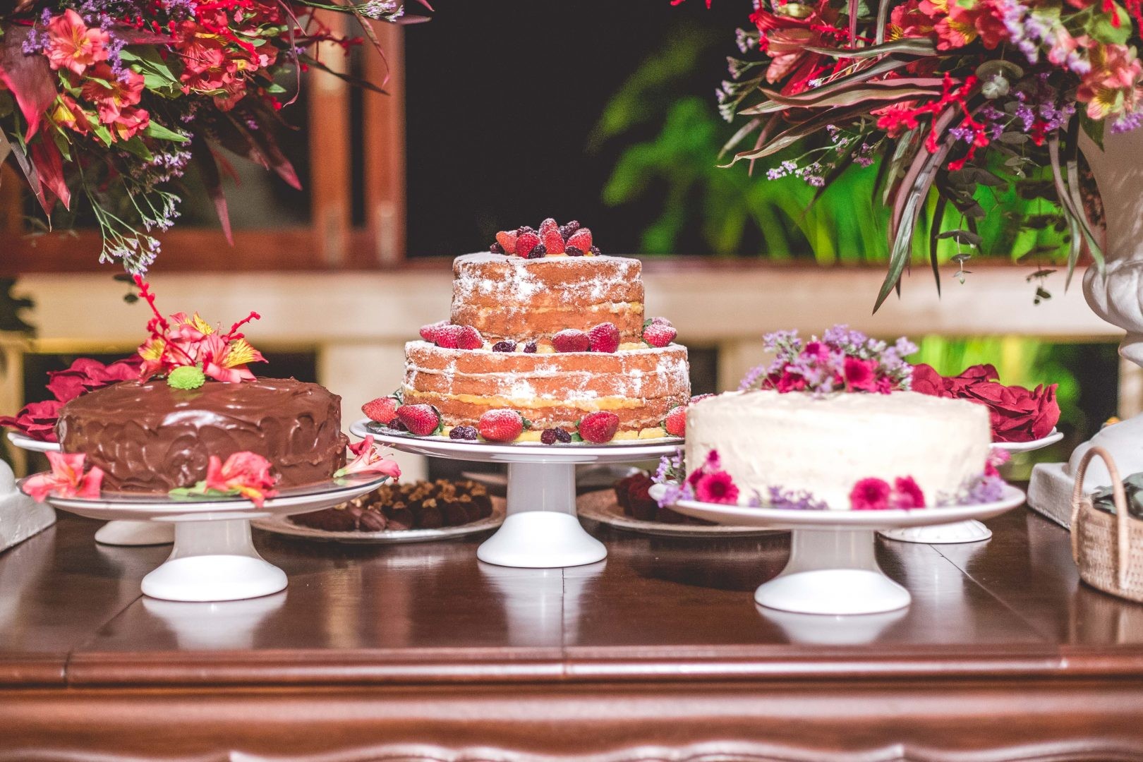 trio de bolos na mesa de doces